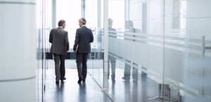 Businessmen talking in office hallway